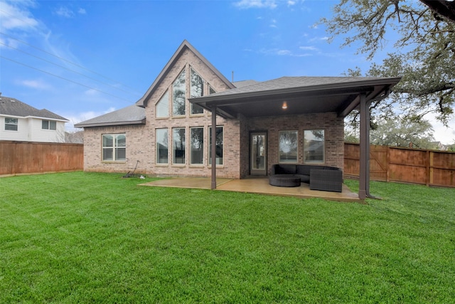 rear view of house featuring an outdoor living space, a patio, and a lawn