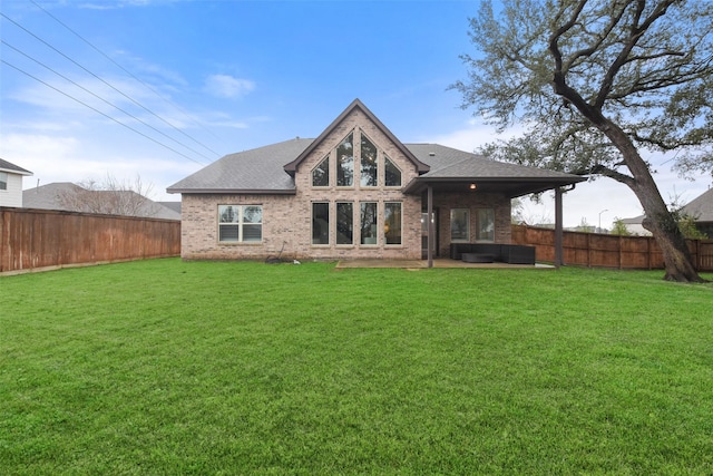 back of property featuring a lawn and a patio