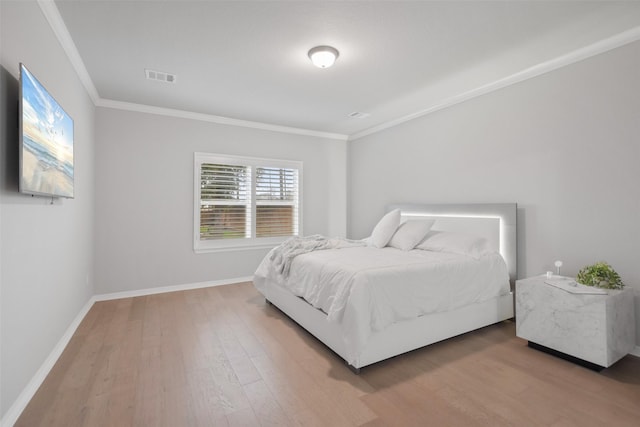 bedroom featuring ornamental molding and wood-type flooring