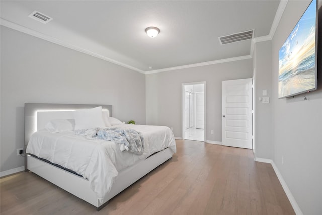 bedroom featuring hardwood / wood-style floors and crown molding