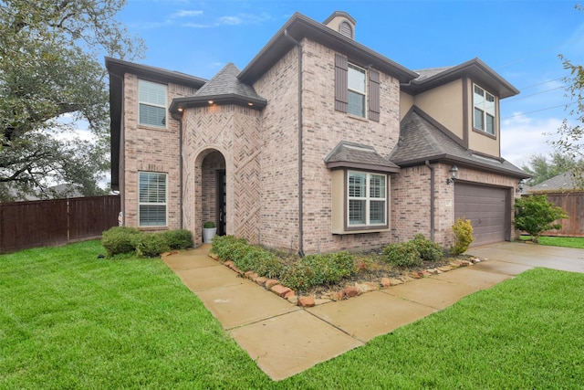 view of front of house with a garage and a front lawn