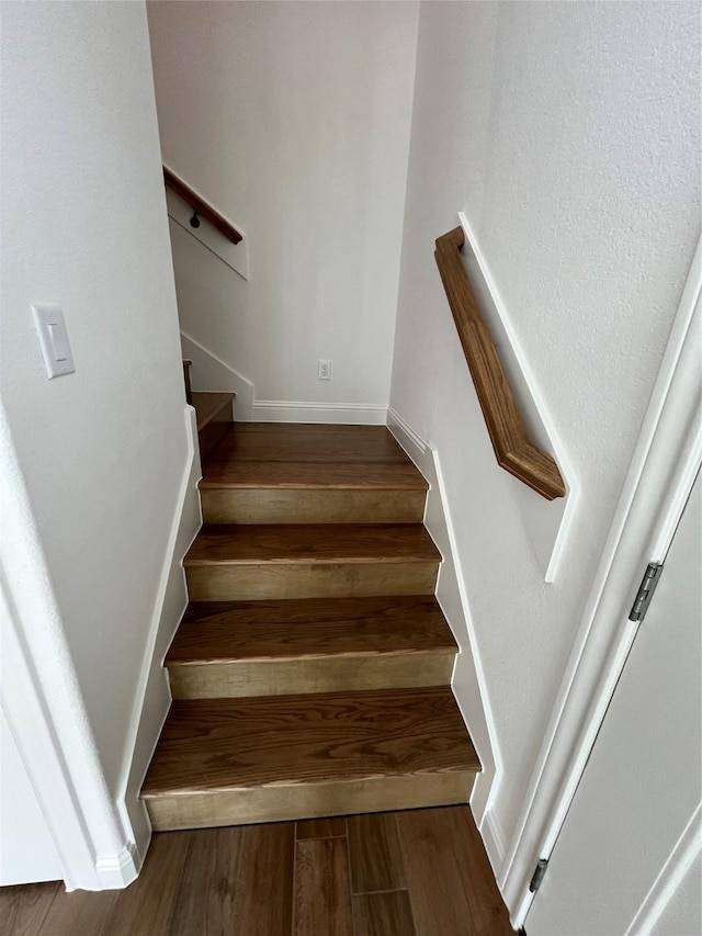 stairway with hardwood / wood-style flooring