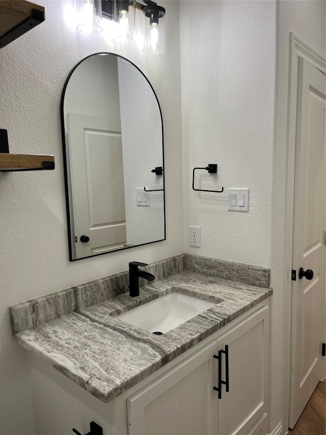 bathroom featuring vanity and hardwood / wood-style floors