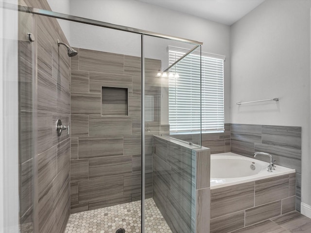 bathroom with shower with separate bathtub