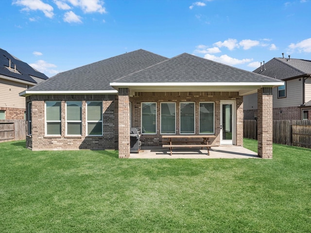 back of property featuring a yard and a patio