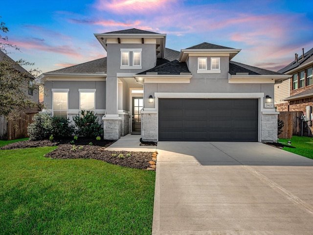 view of front facade with a garage and a lawn