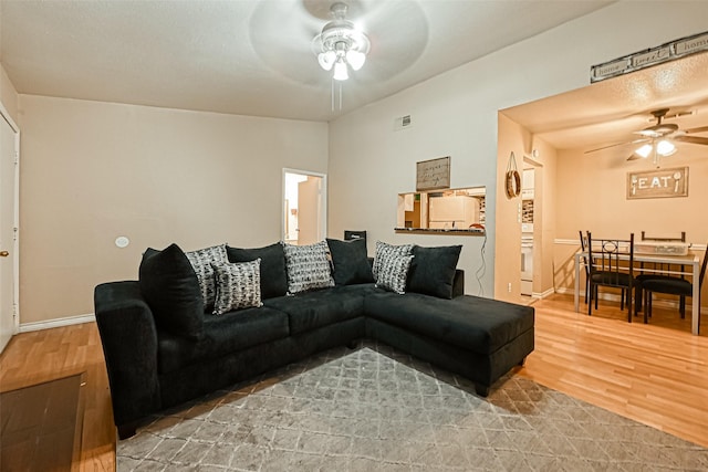 living room featuring hardwood / wood-style flooring and ceiling fan