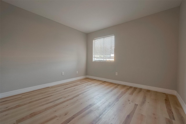 empty room with light hardwood / wood-style flooring