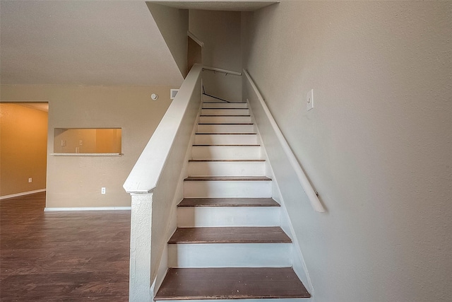 staircase featuring hardwood / wood-style floors