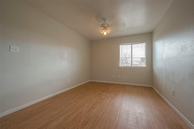 spare room featuring ceiling fan and light hardwood / wood-style floors