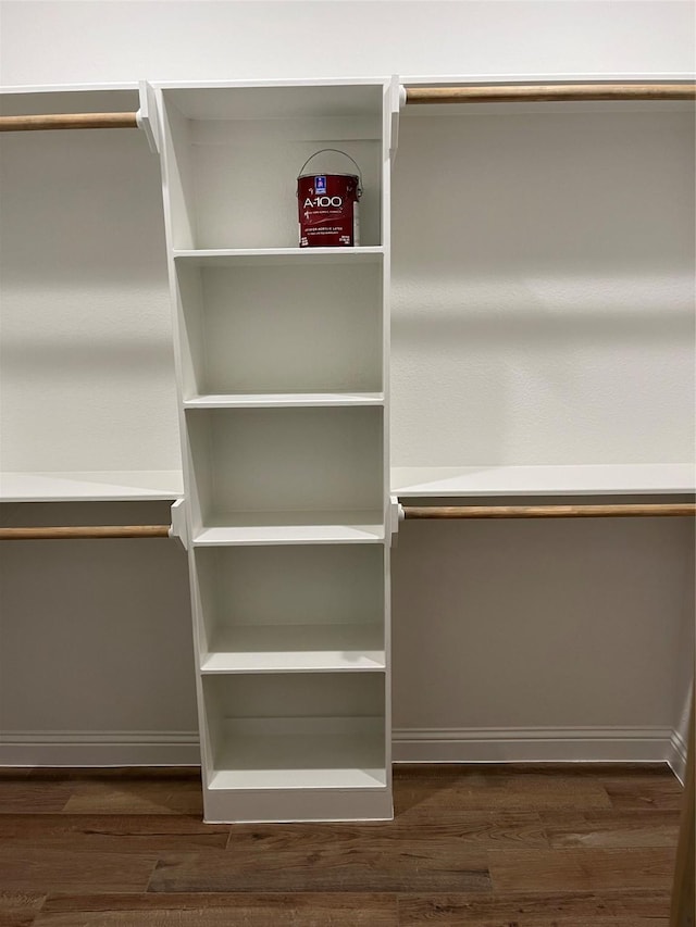 spacious closet with dark hardwood / wood-style floors