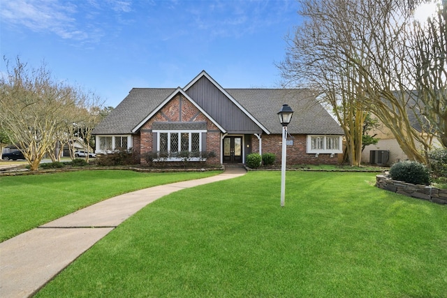 view of front of home featuring a front yard and cooling unit