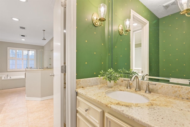 bathroom with vanity, tile patterned flooring, and a washtub