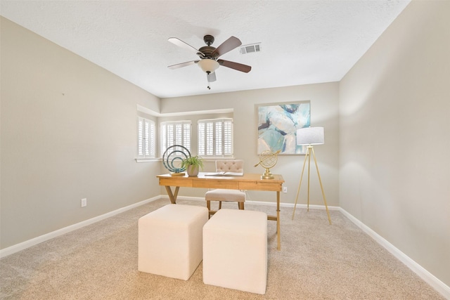 office featuring ceiling fan, carpet floors, and a textured ceiling