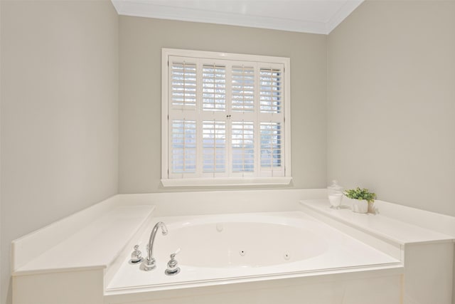 bathroom featuring a bath and crown molding