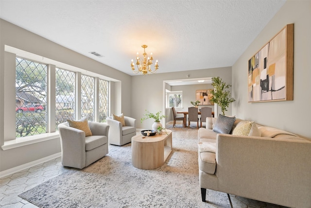 living room featuring a chandelier and a textured ceiling