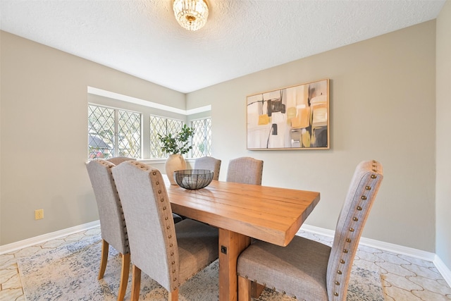 dining space with a textured ceiling