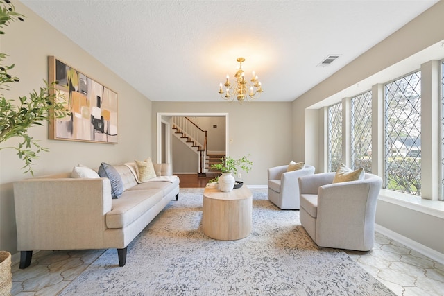 living room with a textured ceiling and a notable chandelier