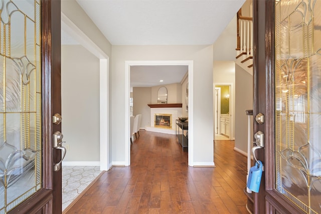 entrance foyer with a fireplace and dark hardwood / wood-style flooring