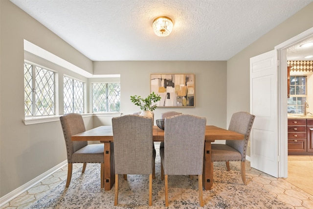 dining room with sink and a textured ceiling