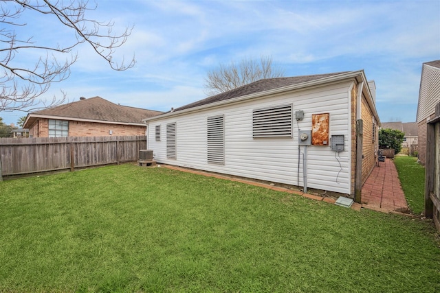 rear view of property featuring a lawn