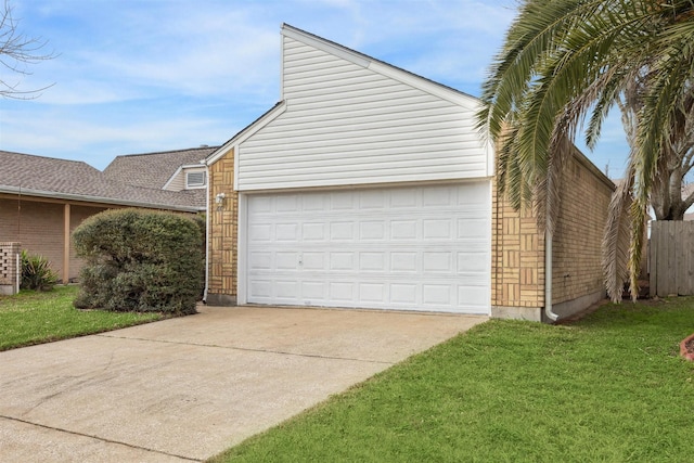 exterior space with a garage and a lawn