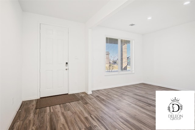 foyer with hardwood / wood-style floors and beam ceiling