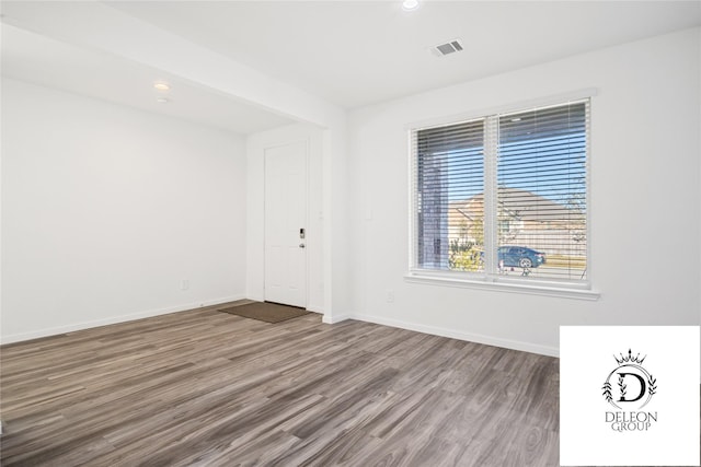 spare room with wood-type flooring