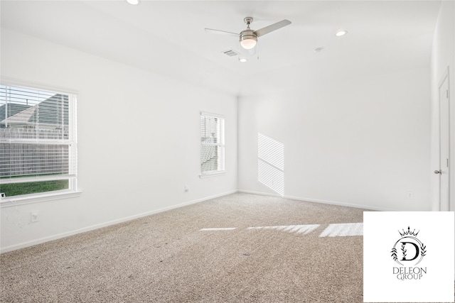 empty room featuring ceiling fan and carpet