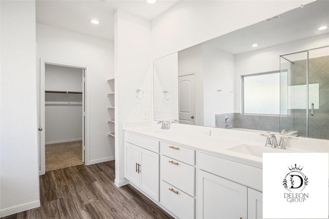 bathroom with vanity, hardwood / wood-style floors, and walk in shower