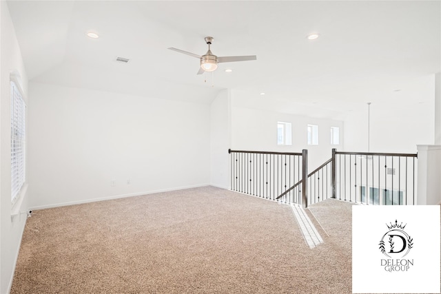 spare room featuring lofted ceiling, carpet floors, and ceiling fan