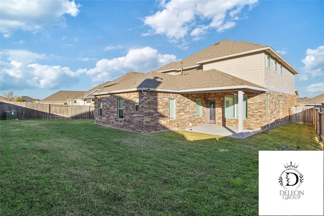 back of house with a yard and a patio