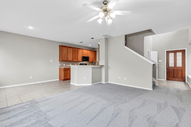 interior space featuring light colored carpet and ceiling fan