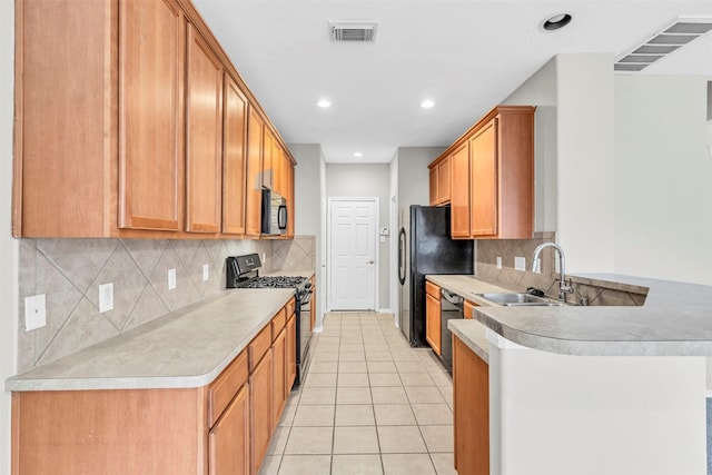 kitchen with sink, light tile patterned floors, tasteful backsplash, black appliances, and kitchen peninsula