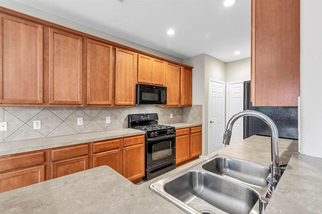 kitchen featuring sink, decorative backsplash, and black appliances