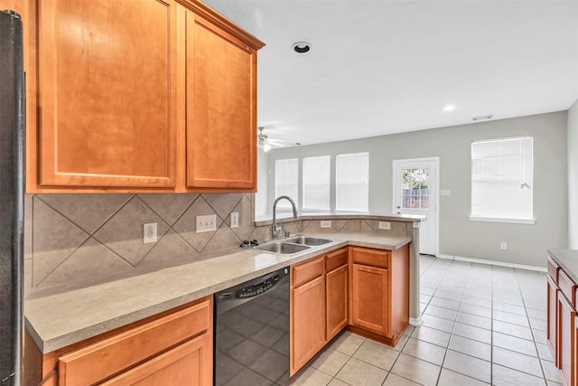 kitchen featuring light tile patterned flooring, dishwasher, sink, decorative backsplash, and ceiling fan