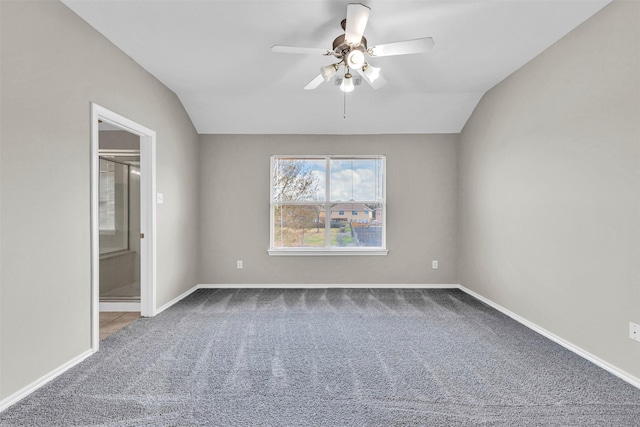 interior space with ceiling fan, vaulted ceiling, and carpet