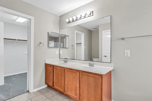 bathroom with vanity, toilet, and tile patterned flooring