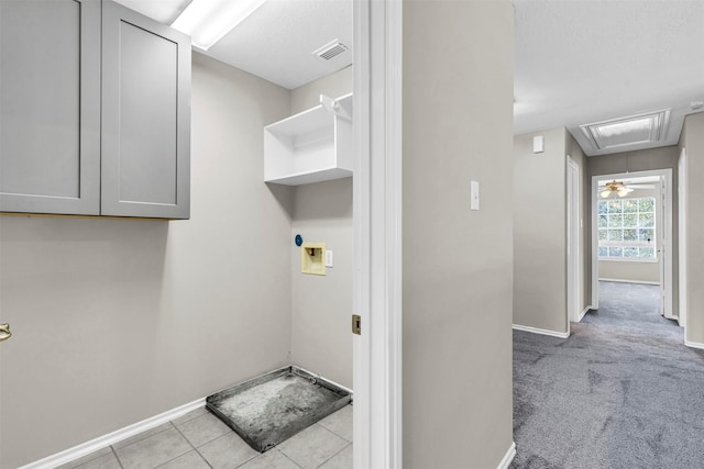 laundry room featuring light tile patterned flooring, washer hookup, and a textured ceiling