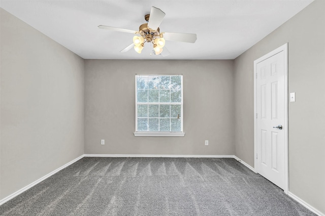 unfurnished room with dark carpet and ceiling fan