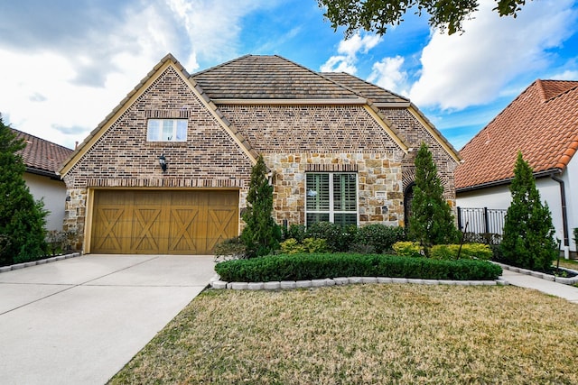 view of front of home with a garage and a front yard