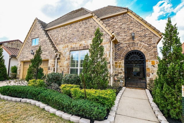 tudor-style house with a garage