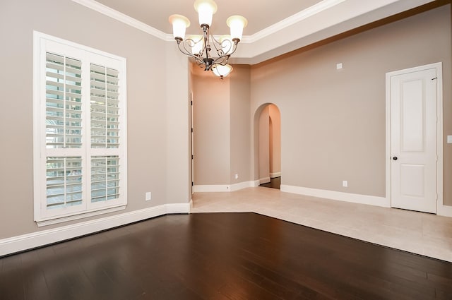 unfurnished room with light hardwood / wood-style flooring, ornamental molding, and a chandelier