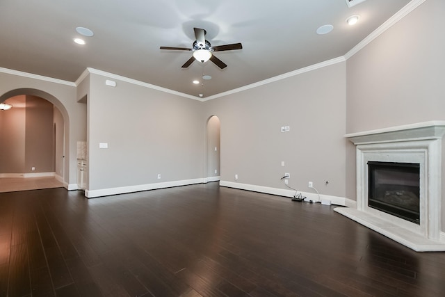 unfurnished living room featuring crown molding, dark wood-type flooring, and ceiling fan