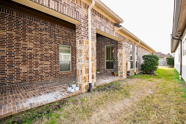 view of home's exterior with a patio area and a lawn