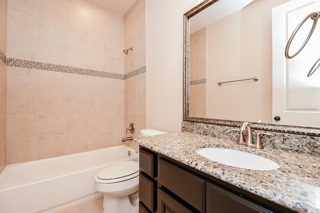 full bathroom with vanity, toilet, and tiled shower / bath combo