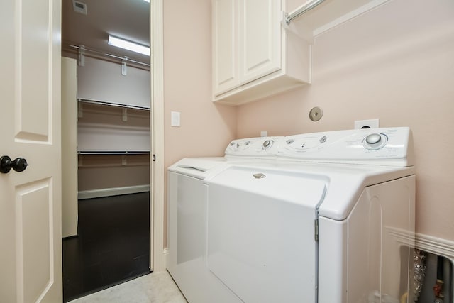 laundry area featuring independent washer and dryer and cabinets