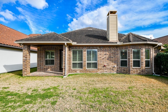 back of house featuring a yard and a patio area