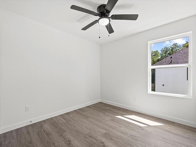 spare room with light hardwood / wood-style floors and ceiling fan