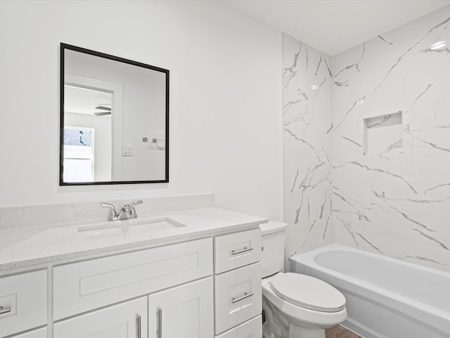 full bathroom with vanity, toilet, and tiled shower / bath combo